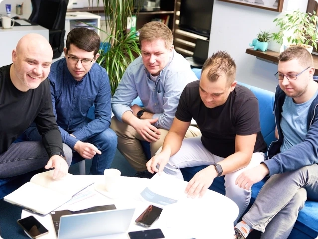 Zdjęcie przedstawia grupę prpacowników pracujących przy projekcie